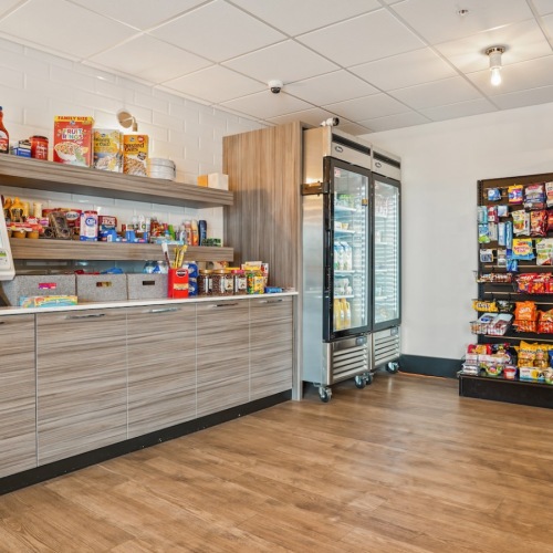 State-of-the-art amenities Resident lounge and snack area The Ivy at Draper 55 and over Apartments in Draper, UT featuring shelves of chips and cookies.
