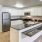 Model kitchen at our senior living apartments in Draper, featuring wood grain floor paneling and stainless steel appliances.